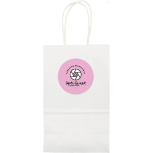 A small white paper bag with handles and a circular logo in pink on the front.