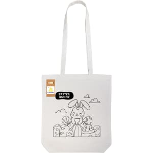 A white tote bag featuring a line drawing of an Easter bunny surrounded by decorated eggs. It has a logo.
