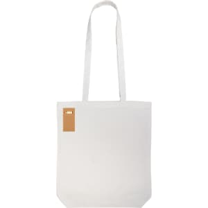 A plain white tote bag with long handles, featuring a small tag and no visible pattern or design.