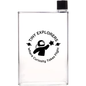A clear drink bottle featuring a black logo with an astronaut and the text "Tiny Explorers" and "Where Curiosity Takes Flight."