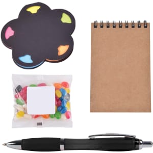 A cloud-shaped sticky note pad, a notepad, a pen, and a pack of colorful jelly beans. All items are neatly arranged.