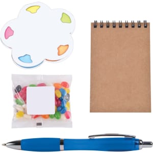 A notepad with a brown cover, a pack of colorful jelly beans, a flower-shaped sticky note pad, and a blue pen.