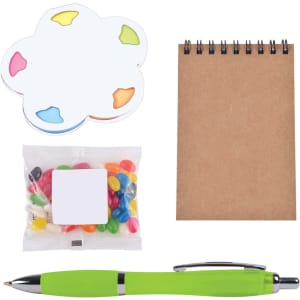 A colorful notepad in the shape of a flower, a small bag of jelly beans, a blank notepad, and a green pen.
