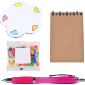 An office gift set including a pink pen, a notepad, jelly beans in a pouch, and a colorful sticky note pad.