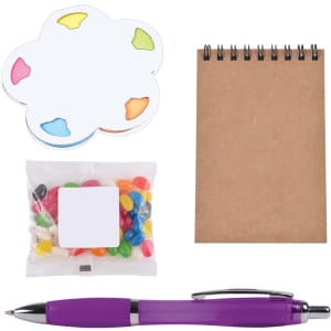 A purple pen, a notepad, a colorful sticky note set, and a packet of jelly beans in various colors.