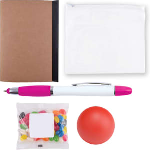 A brown notebook, a white zip pouch, a pink and white pen, a red stress ball, and a bag of colorful candies.