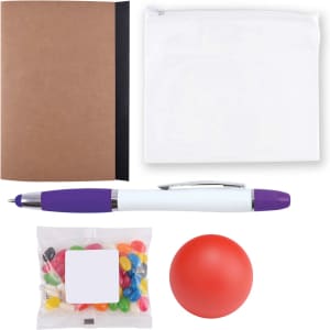 A notebook, a clear zip pouch, a purple and white pen, a bag of colorful jelly beans, and a red stress ball.