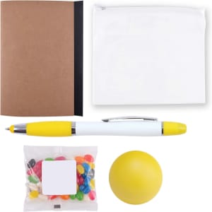 A notebook, a clear zip pouch, a pen with a yellow cap, a bag of colorful jelly beans, and a stress ball.