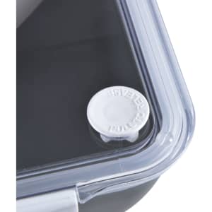 A black lunch box with a clear lid and a white pull-tab for secure sealing. It features a logo on the lid.