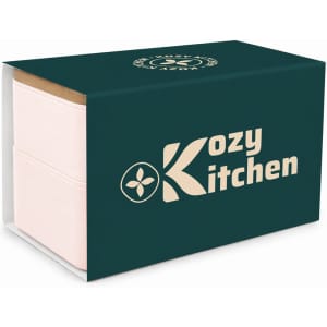 A two-tier lunch box in pastel pink with a dark green box featuring a logo.