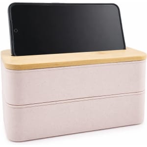 A pink eco lunch box with a bamboo lid and a phone holder, featuring a simple and modern design.
