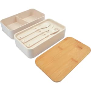A Stax Eco Lunch Box in beige with a bamboo lid and utensils, featuring a divided interior for organisation.