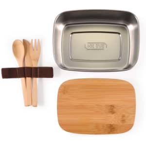 A stainless steel lunch box in silver with a bamboo lid, accompanied by wooden utensils and a fabric tie.