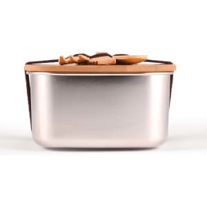 A silver lunch box with a tan leather strap and a smooth, metallic finish. It features a simple design and no visible branding.