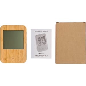 A weather station with a bamboo frame, a user manual, and a cardboard box.