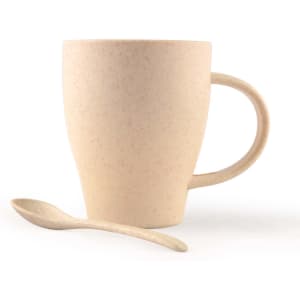 A drink cup in light beige with a handle and a matching spoon, made of wheat fibre material.