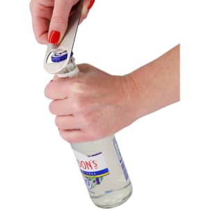 A drink bottle opener in silver is being used to open a bottle with a woman's hand gripping it.