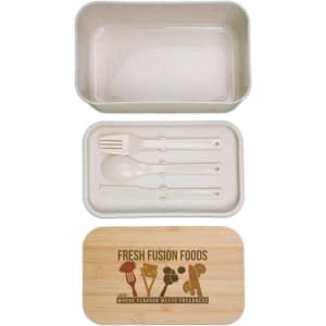 A beige lunch box with a bamboo lid, containing utensils including a fork and spoon. It features a logo.
