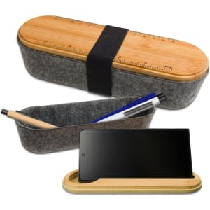 A gray felt utility case with a bamboo lid, featuring a ruler design and holding a pen and phone.