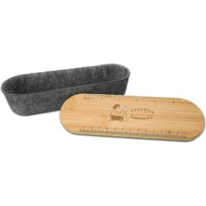 A Mansfield Utility Case featuring a felt container and a bamboo lid with a ruler design.