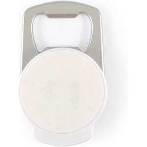 A drink bottle opener phone stand in silver and white, featuring a circular space in the center and a logo.