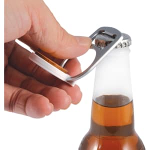 A drink bottle opener in silver, designed as a phone stand, being used to open a glass bottle.