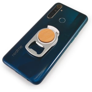 A drink bottle opener integrated into a phone stand, featuring a wooden accent, attached to the back of a smartphone.