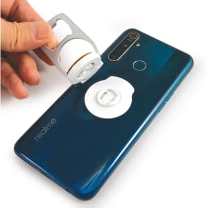 A drink bottle opener in silver being held above a blue smartphone with a white phone stand attached.