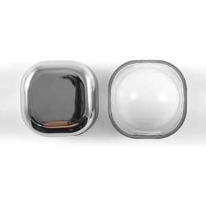 A shiny chrome cosmetic container and a white jar, both with a sleek, modern design.