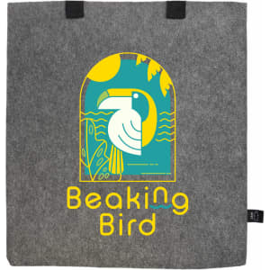 A grey felt tote bag with a colourful graphic featuring a bird, plants, and sun. It has two black handles.