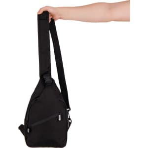 A black shoulder bag with a single strap, featuring a zippered pocket and a hand holding it.