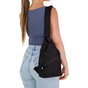 A sleek black wallaby neck pouch is worn over the shoulder, featuring a zippered pocket and adjustable strap.
