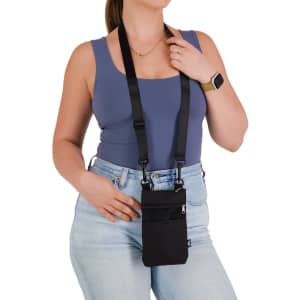 A black neck pouch with adjustable straps is worn by a person, featuring a front pocket and a logo.