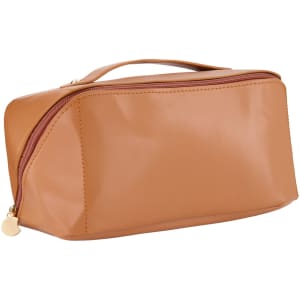 A tan toiletry bag with a smooth finish and a zippered closure, featuring a handle on top and a logo.