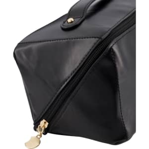 A black toiletry bag with a geometric design and a gold zipper detail, featuring a handle for easy carrying.