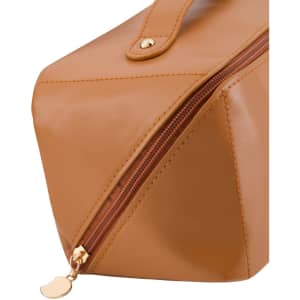 A tan toiletry bag with a gold zipper, featuring a sleek design and a branding logo.