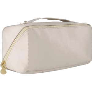 A light beige toiletry bag with a gold zipper and a handle, featuring a logo on the side.