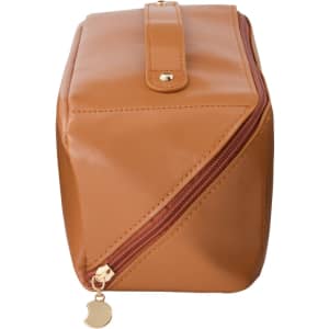 A tan toiletry bag with a gold zipper and a logo, featuring a rectangular design and a secure closure.