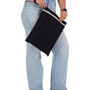 A black wet bag being held by a person, featuring a white zip and a sleek design.