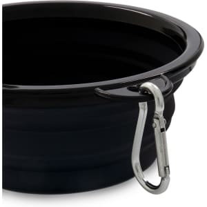 A black collapsible bowl with a silver carabiner attached to the rim for easy carrying.