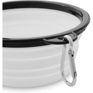 A collapsible bowl in white with a black rim, featuring a metal carabiner for easy attachment.