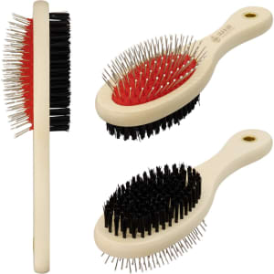 A pet grooming brush featuring a mix of black and red bristles with a light cream handle. Includes a logo.