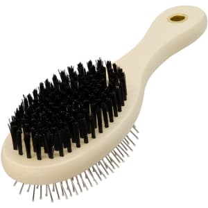 A pet grooming brush with a cream handle and black bristles, featuring metal pins for fur removal.