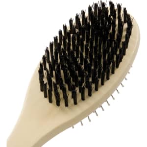 A pet grooming brush with a beige handle and black bristles, featuring a curved shape for comfortable use.