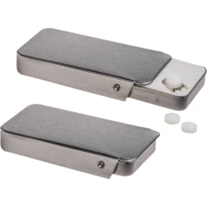 A silver slider tin containing sugar-free breath mints, with a few mints visible outside.