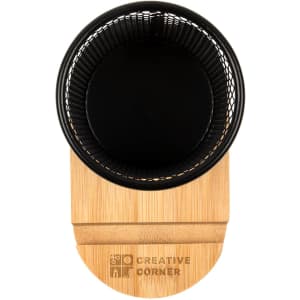 A black wire mesh pen tidy with a bamboo base. The base features a logo.