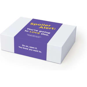 A rectangular white box with a purple label, featuring text and a logo. The box has a smooth surface.