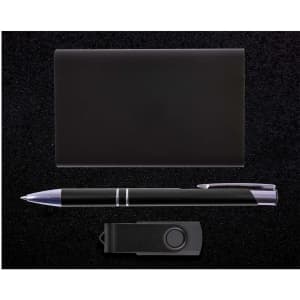 A Quay Gift Set featuring a sleek black pen, a cardholder, and a USB flash drive, all presented on a black background.