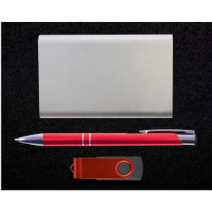 A power bank, a silver card holder, a red pen, and a USB flash drive are displayed in the Quay Gift Set.