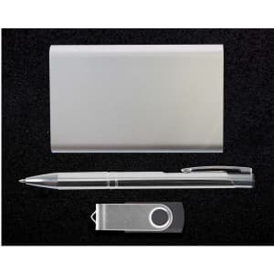 A sleek metal card holder, a silver pen, and a USB flash drive are arranged together in a minimalistic presentation.
